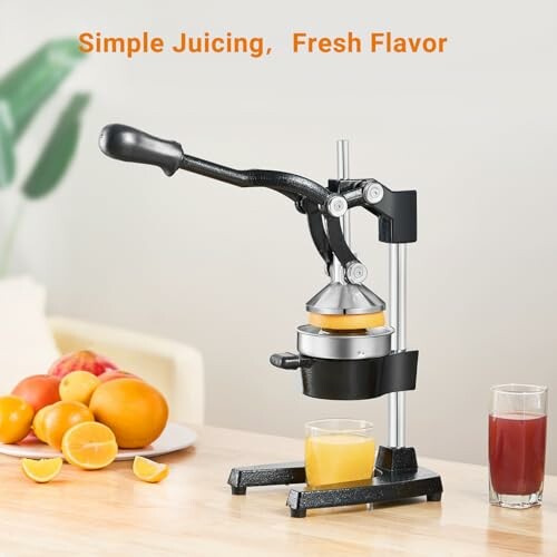 Manual citrus juicer with fresh juice and oranges on table.