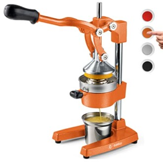 Manual citrus juicer with lever, squeezing orange juice into a cup.