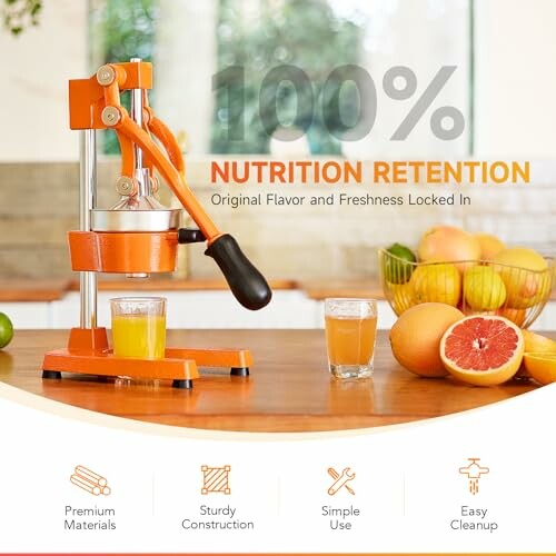 Manual juicer on kitchen counter with fresh juice and fruits.
