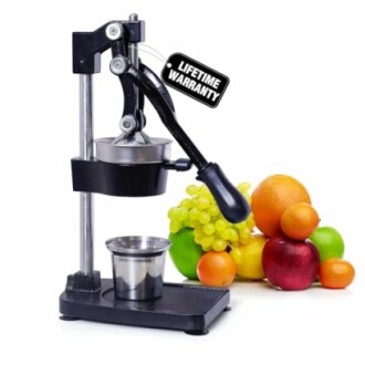 Manual juicer with various fruits including apples, oranges, and grapes.