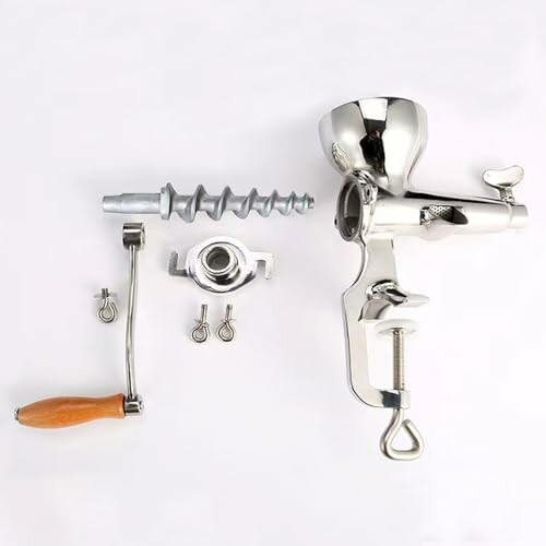 Disassembled manual meat grinder with components on white background.