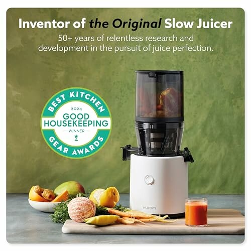 Award-winning slow juicer with fruits and juice.