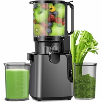 Slow juicer with fruits and vegetables, including celery and green juice.